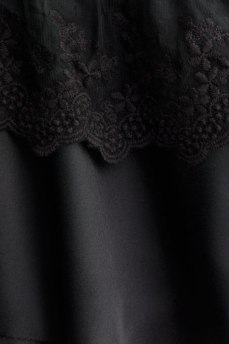 Flounce-trimmed satin blouse